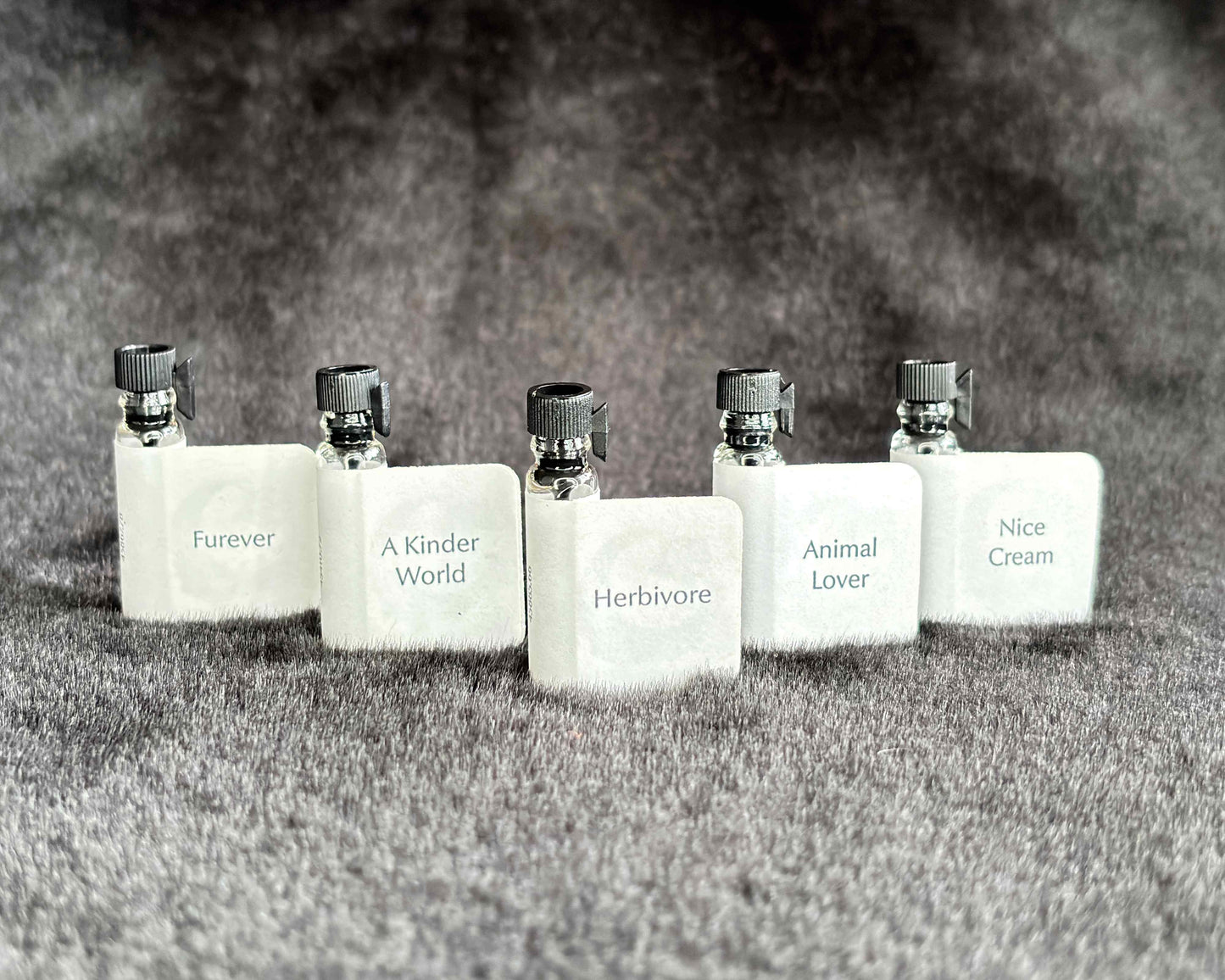 All five Animal Lover Collection sample bottles lined up on a furry blanket.