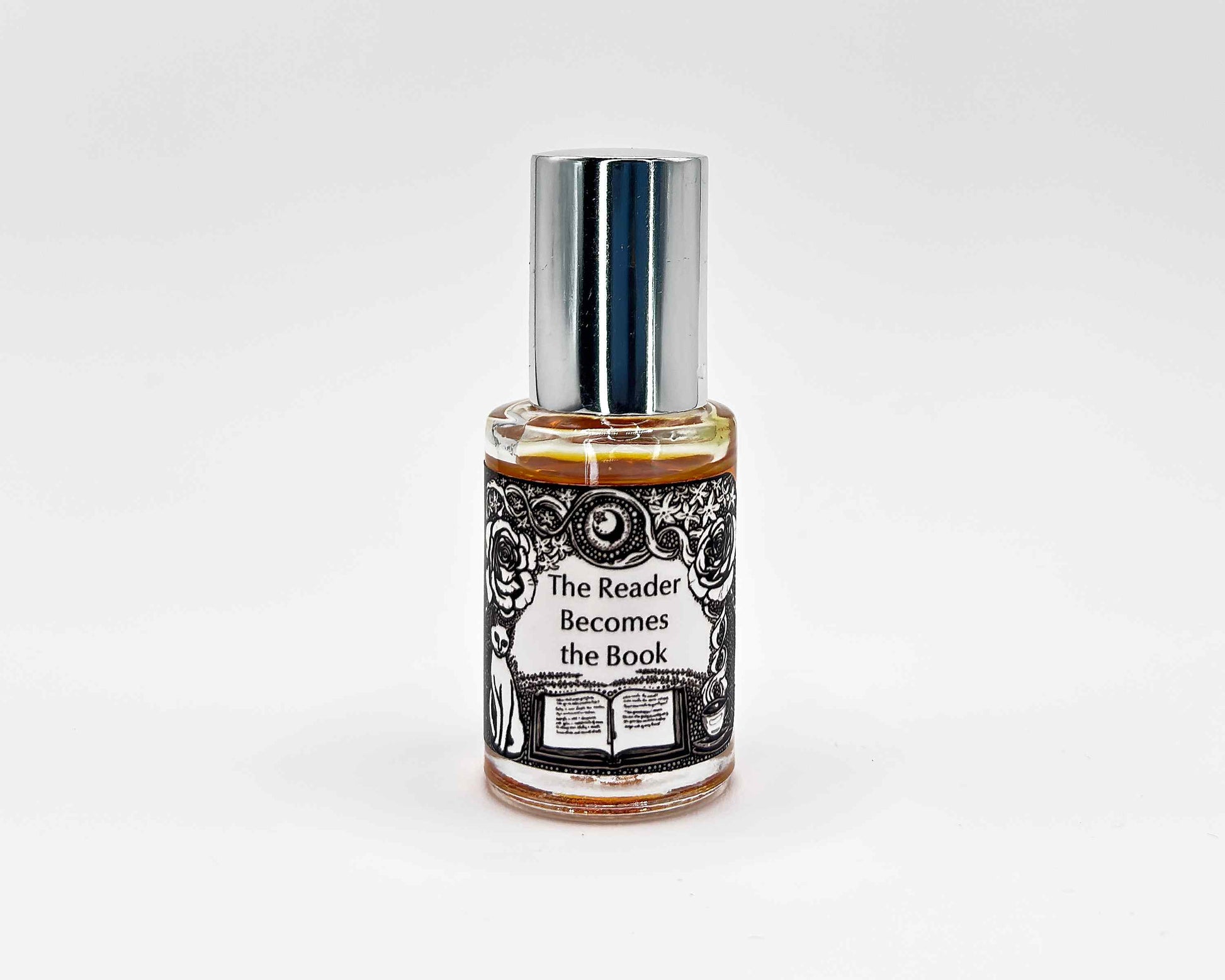 The Reader Becomes the Book Fragrance 5mL bottle. Cylindrical clear glass with Gt Lit Collection artwork label and a cylindrical silver top.
