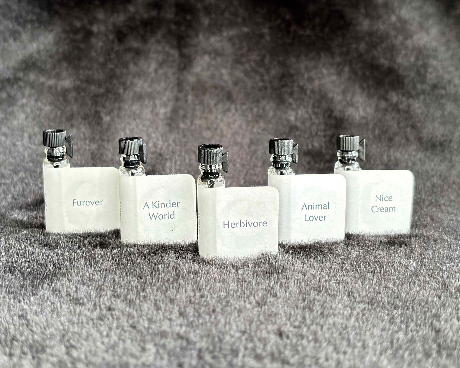 All five Animal Lover Collection sample bottles lined up on a furry blanket.