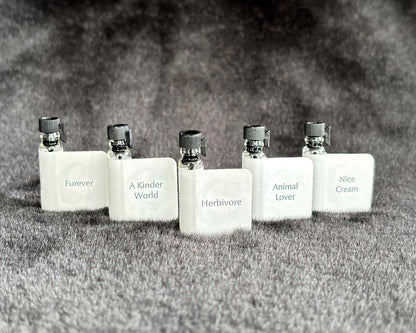 All five Animal Lover Collection sample bottles lined up on a furry blanket.