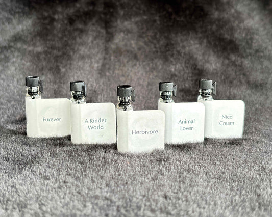 All five Animal Lover Collection sample bottles lined up on a furry blanket.