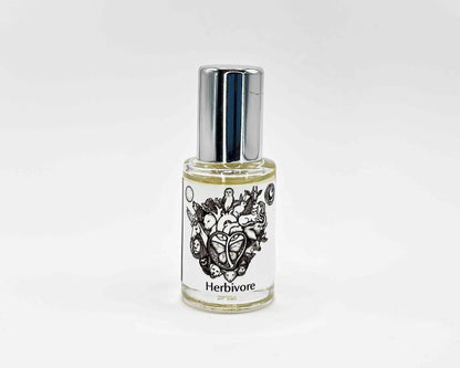 Herbivore Fragrance 5mL bottle. Cylindrical clear glass with Animal Lover Collection artwork label and a cylindrical silver top.