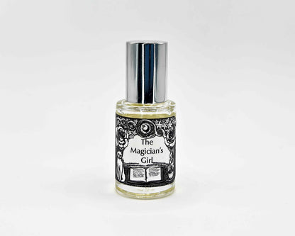 The Magician's Girl Fragrance 5mL bottle. Cylindrical clear glass with Get Lit Collection artwork label and a cylindrical silver top.