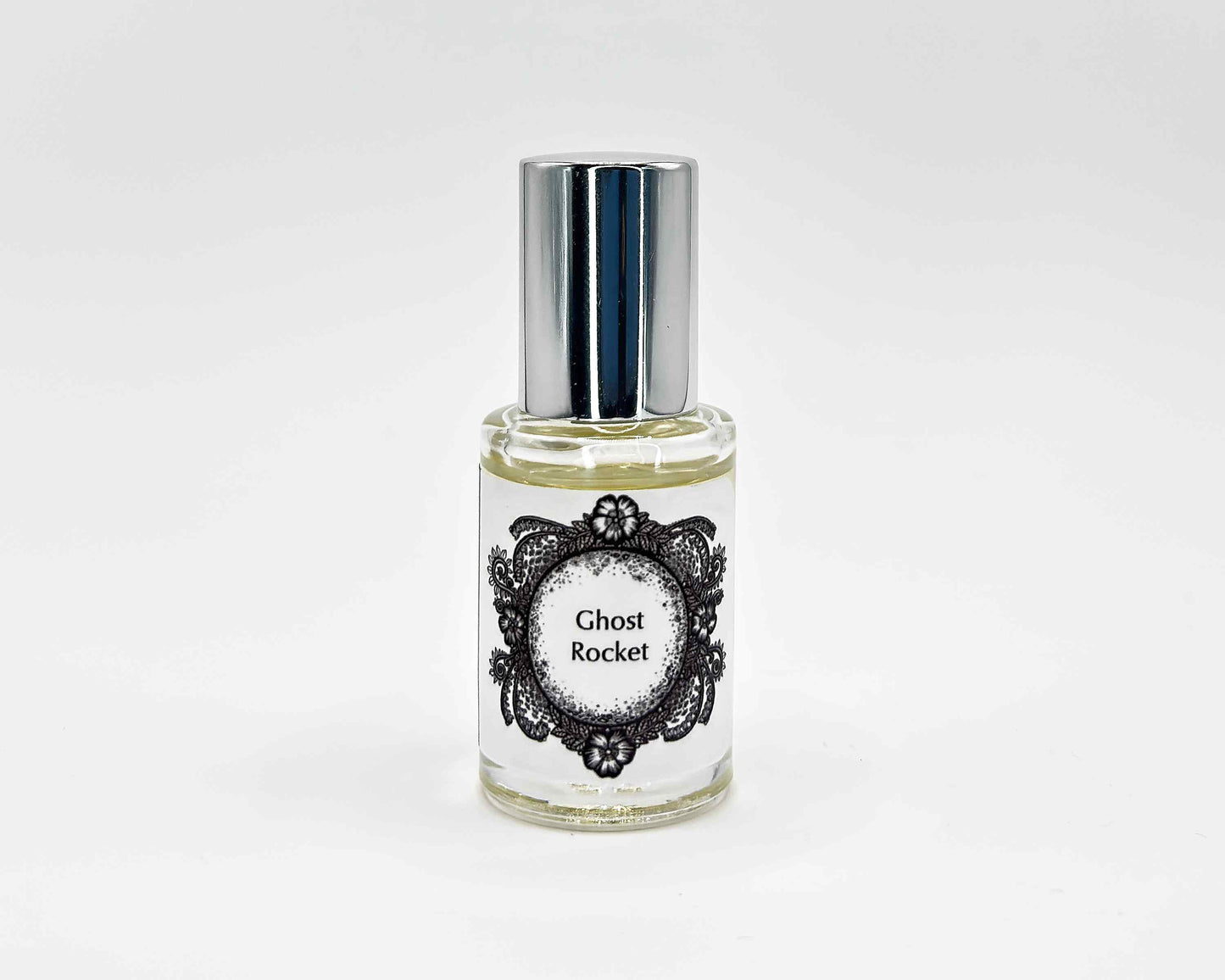 Ghost Rocket Fragrance 5mL bottle. Cylindrical clear glass with Life on the Moon Collection artwork label and a cylindrical silver top.