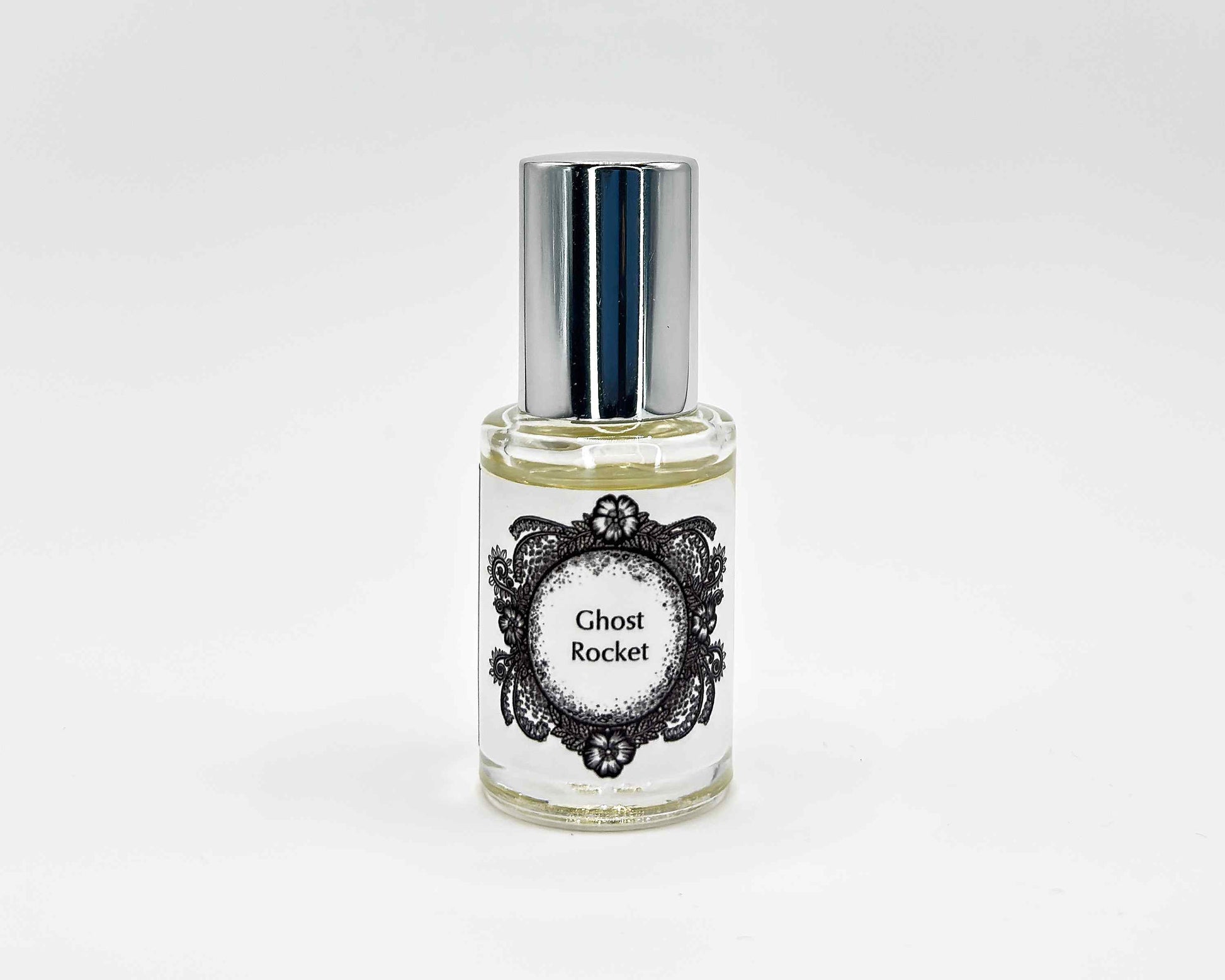 Ghost Rocket Fragrance 5mL bottle. Cylindrical clear glass with Life on the Moon Collection artwork label and a cylindrical silver top.