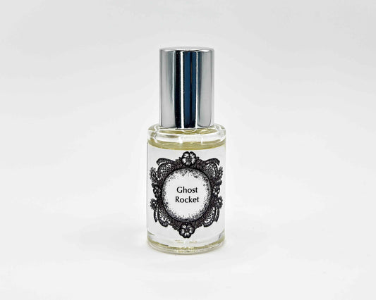 Ghost Rocket Fragrance 5mL bottle. Cylindrical clear glass with Life on the Moon Collection artwork label and a cylindrical silver top.