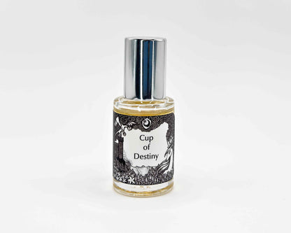 Cup of Destiny Fragrance 5mL bottle. Cylindrical clear glass with Lost Fairytale Collection artwork label and a cylindrical silver top.