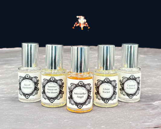 All five Life on the Moon Collection 5 mL bottles lined up on a moonscape with a lunar lander in the background.