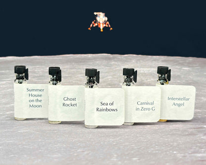 All five Life on the Moon Collection sample bottles lined up on a moonscape with a lunar lander in the background.