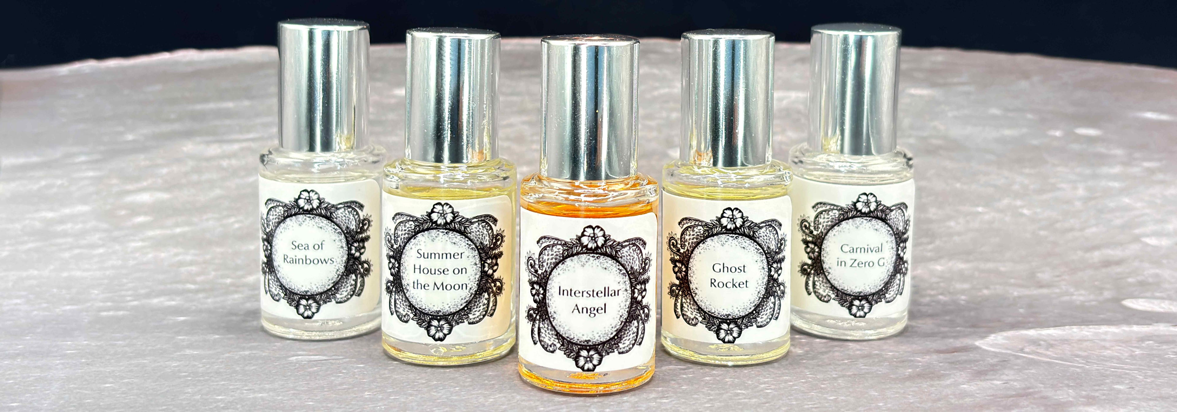 All five Life on the Moon Collection 5 mL bottles lines up on a moonscape.