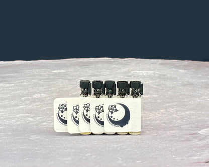 Five sample bottles lined up on a moonscape.